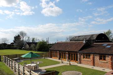 The fully enclosed garden has open views across the fields, and a hot tub and sauna in a private corner.