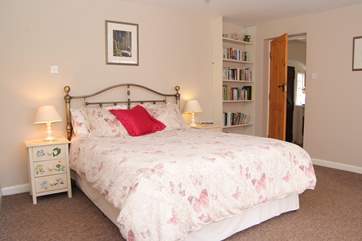 The double bedroom is really spacious, with fitted bookshelves and plenty of storage space.