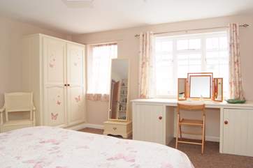 Another view of this spacious bedroom. The windows look out into the covered utility and perfect dog drying-area.