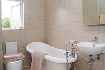 The newly refurbished bathroom has a wonderful roll top bath.