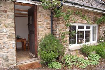 The cottage is prettily planted along the front.