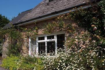 This pretty cottage feels very private and has its own little sitting-out area around to the side.