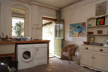 The utility-room leads out to the enclosed cobbled courtyard, shower and swimming pool.