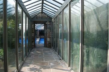 An interior walkway leads to the pool.