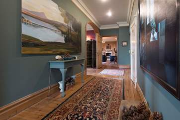 The first floor hallway leads to the library and a study-area.