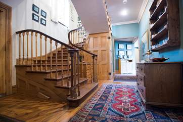 Stairs sweep down from the second floor.