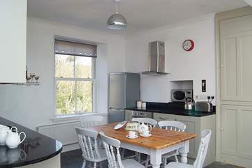 The kitchen units are painted a lovely soft green and are fitted with granite worktops.