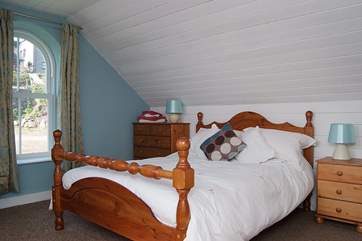 Spacious Bedroom 2, on the left at the top of the stairs, is furnished with a double bed.