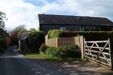 The view down the lane as you approach. The parking-area is inside the five-bar gate.