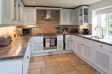 Light pours into this lovely well-equipped kitchen.