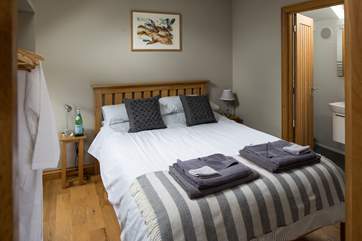 The comfortable double bedroom has a 5' bed and en suite shower-room.