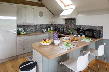A breakfast-bar cleverly separates the kitchen from the living space.