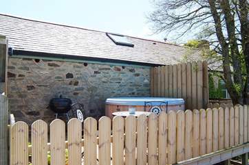 The private hot tub enclosure is behind the cottage, just a few strides along the deck from the front door. Relax and indulge yourselves!