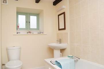 Bathroom with bath and fitted shower.