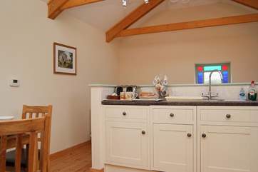 Pass the kitchen-area to the stairs down to the ground floor.