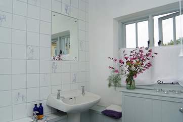 The bathroom has a bath and a fitted shower.
