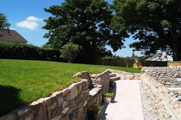 A little stone seat has been built into one of the retaining walls.