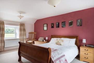 Spacious Bedroom 1 is furnished with a king-size sleigh bed.