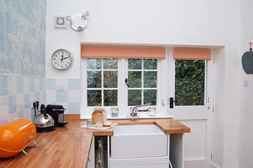 The window over the sink looks over the private patio behind the cottage.