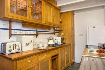 The galley kitchen is perfectly in keepng with the cottage.