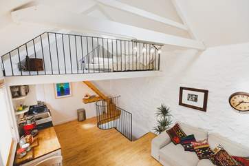 The first floor living-area has steep steps up to the second floor mezzanine snug.