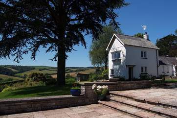 This is a view of The Mouse House from the owners' side of the garden. Your garden and seating area face out across the valley to the far side of the property.