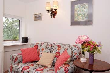 The sitting-area has a comfortable sofa as well as an armchair.