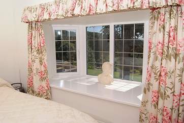 The master bedroom has this lovely wide window sill looking out to the front of the cottage.