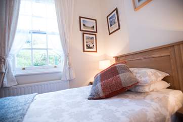 The tall sash window looks out to the rear terrace.