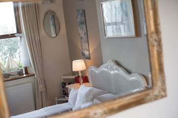 A gilt-framed mirror adds a touch of opulence.