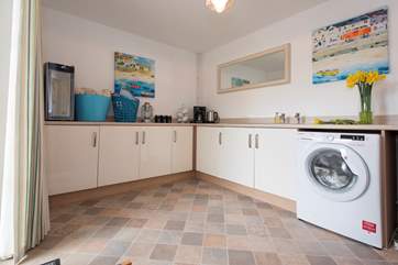 The spacious utility-room on the lower ground floor is fully equipped for outdoor eating with a wine fridge and tea/coffee making facilities.