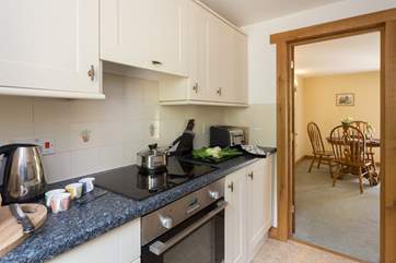 The kitchen leads directly into the dining area of the living room.