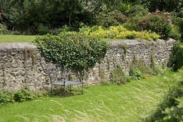 There is a little hidden away seat by the stream. Perfect for that evening glass of wine.