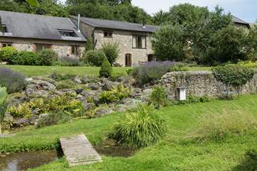 This images shows the overall setting, taken from the far side of the stream and looking back towards the cottage which is on the right.