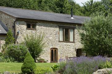 Purtington Barn Cottage has a beautiful outlook over the gardens which include a little stream and a wildlife pond where you can sit in peace and quiet.