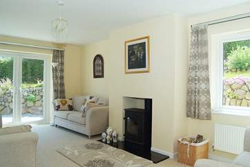 The sitting-room includes a welcoming wood-burner.