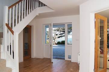 Glass doors to all the downstairs rooms enhance the sense of space and light throughout the house.