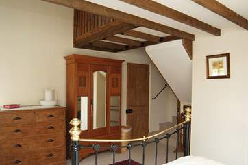 Stairs in the double bedroom go up to the galleried single bedroom above.