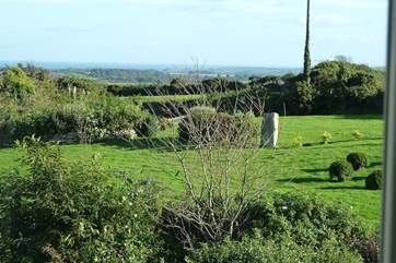 This beautiful house and garden enjoy lovely views towards the sea in the distance.