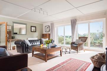 This fabulous sitting-room overlooks the garden, in the warm weather you can open up the doors and let the outside in.