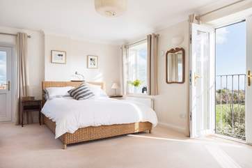 Spacious Bedroom 2 includes a door which opens out to exterior stone steps leading down to the garden (to the left of the photo).