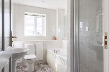 The first floor family bathroom includes a luxurious jacuzzi bath in addition to the separate shower cubicle.