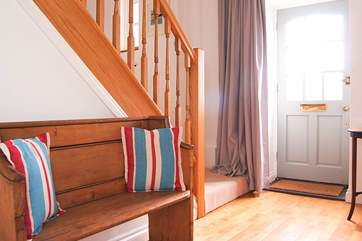 Somewhere to sit to take off your shoes and a step up into the huge sitting-room.