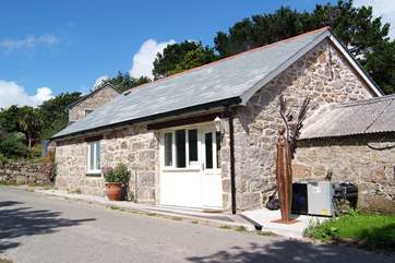 The pretty cottage sits on the edge of a quiet country lane.