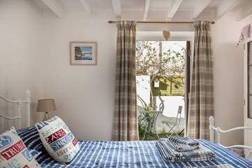 French doors lead out from Bedroom 1 to a little tucked-away courtyard.
