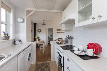 The galley-style kitchen is extremely well-equipped and leads through into the main living area.