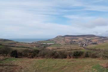 The panoramic view across the valley from a local footpath. The Linhay is amongst the nearest group of buildings and Chideock village is to the right.
