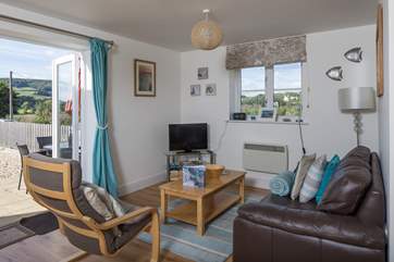 This welcoming open plan living area has French windows straight out onto the enclosed patio.