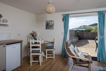 The dining table fits very comfortably into the corner of the room.