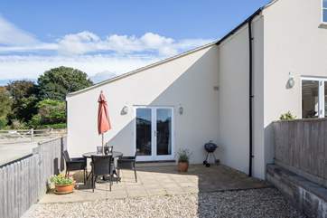 The sheltered patio leads from the open plan living area.